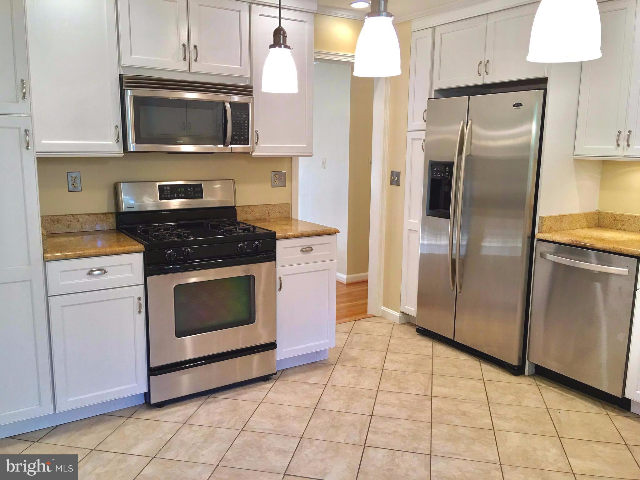 1003 Dead Run Drive McLean, VA 22101 - Photo 3 of 26 a kitchen with cabinets stainless steel appliances and a counter top space