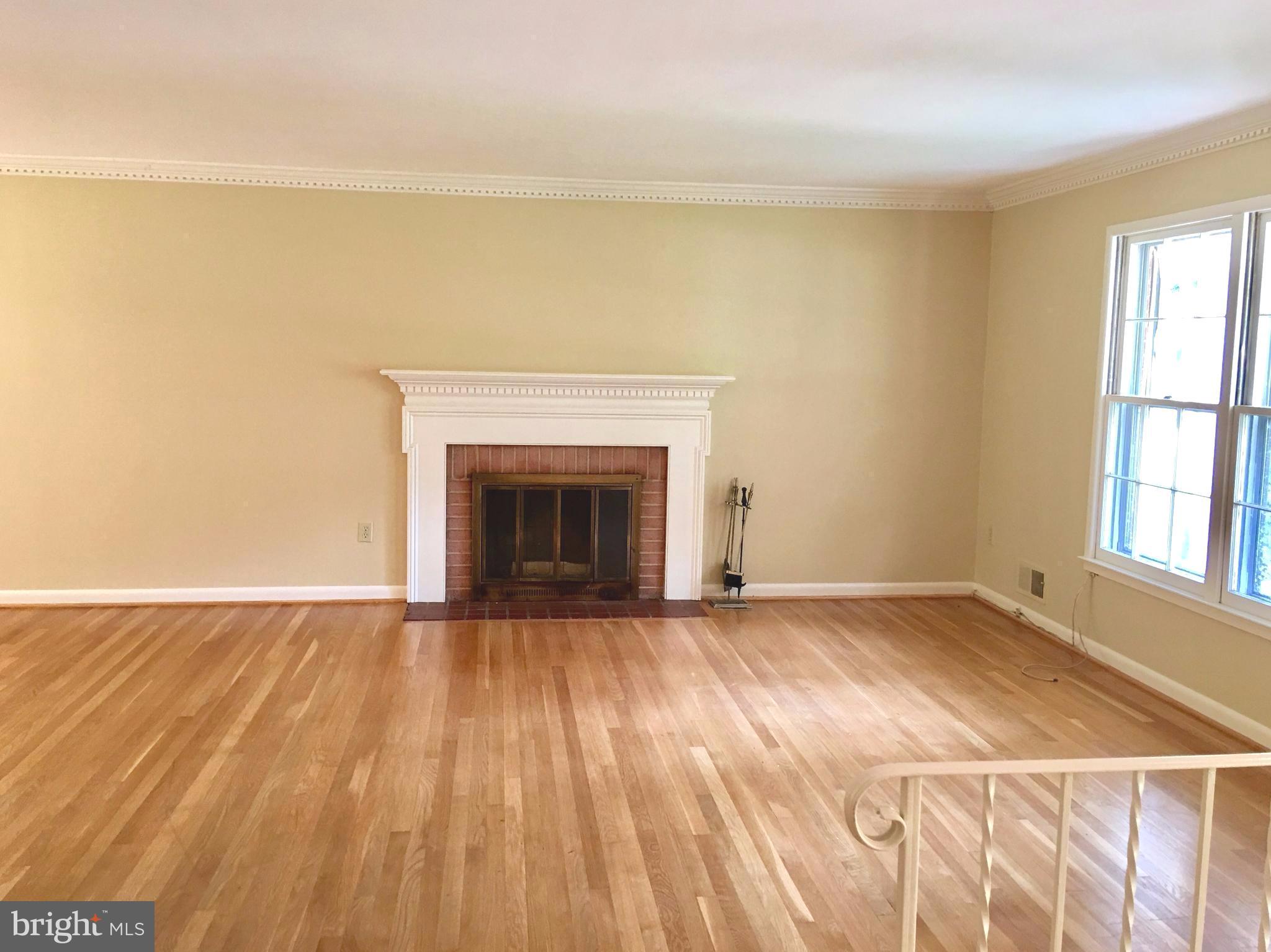 1003 Dead Run Drive McLean, VA 22101 - Photo 8 of 26 a view of empty room with wooden floor and fireplace