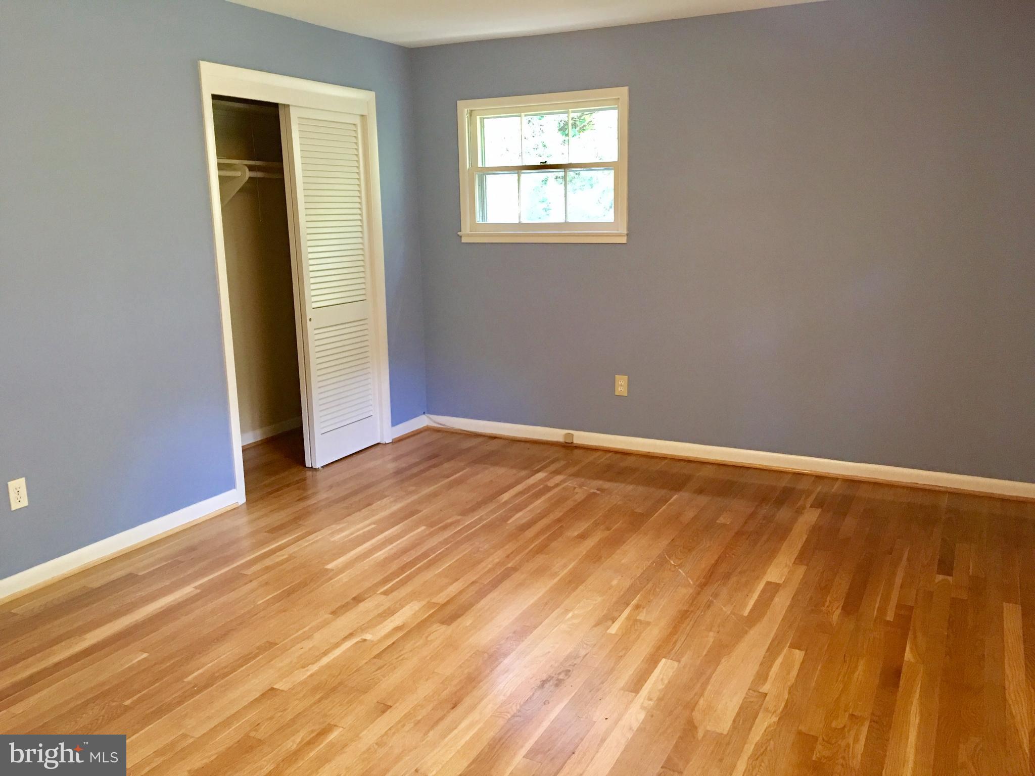 1003 Dead Run Drive McLean, VA 22101 - Photo 10 of 26 a view of an empty room with wooden floor and a window