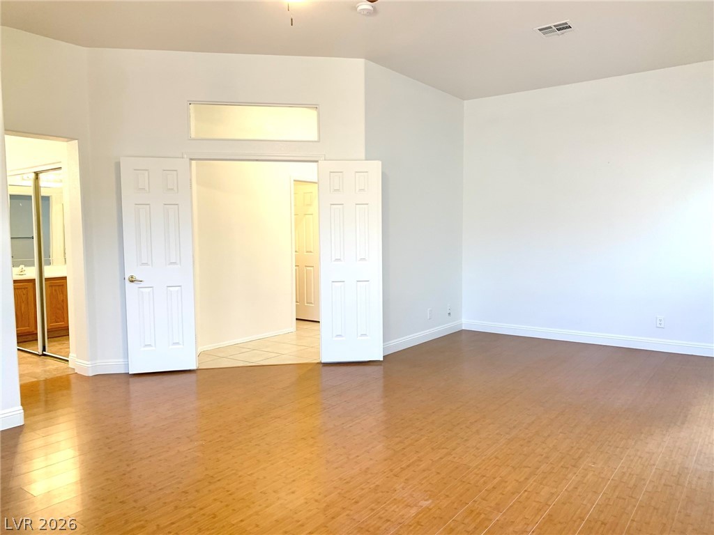 3821 Bombastic Court Las Vegas, NV 89147 - Photo 24 of 36 This airy room features warm wood flooring and access to an adjacent bathroom.