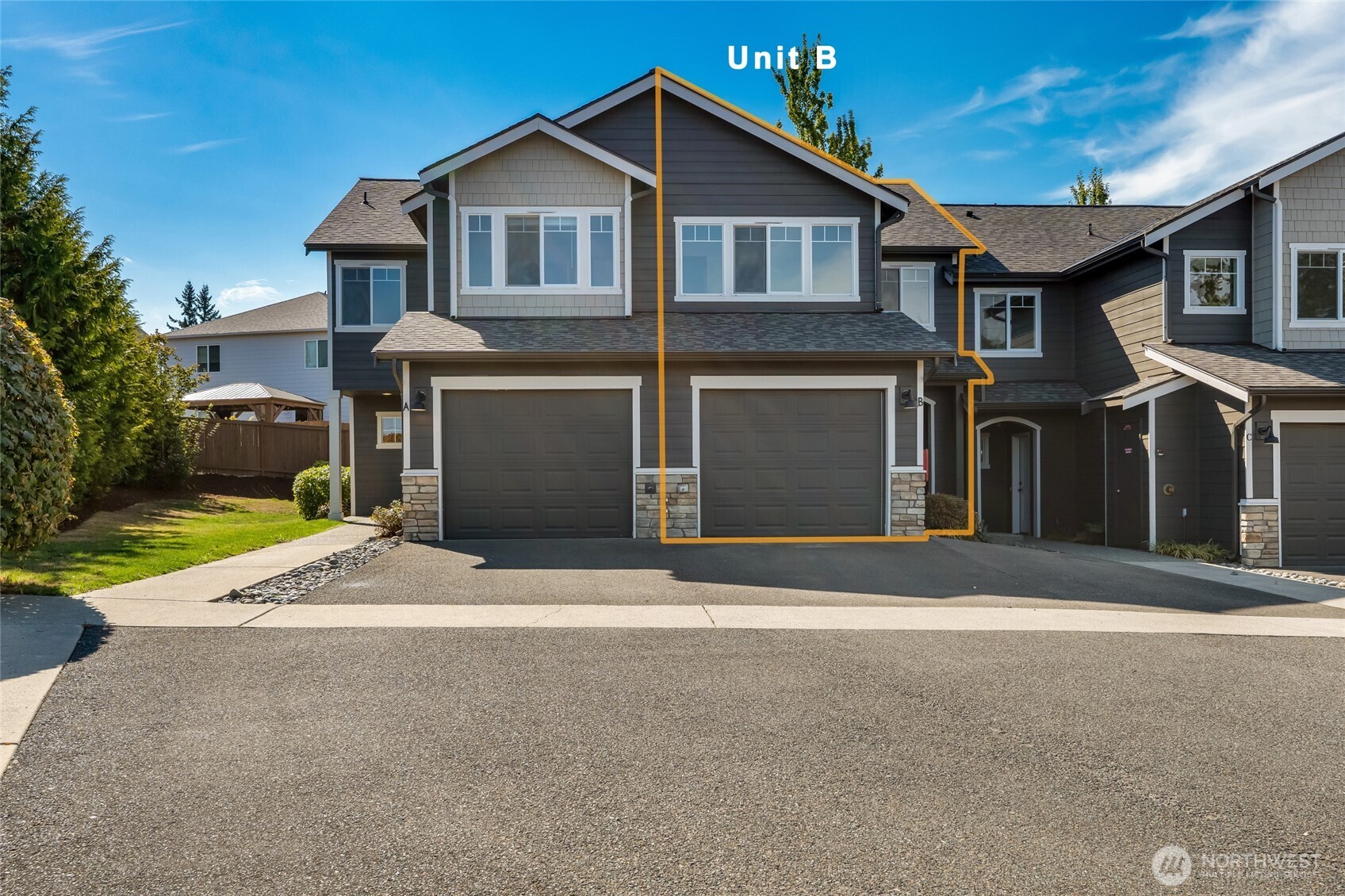 3910 132nd Street Southwest, Unit B Lynnwood, WA 98087 - Photo 2 of 30 a front view of a house with a yard and garage