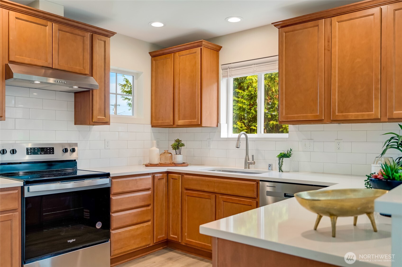 3910 132nd Street Southwest, Unit B Lynnwood, WA 98087 - Photo 7 of 30 a kitchen with stainless steel appliances a sink a stove a refrigerator cabinets and a window