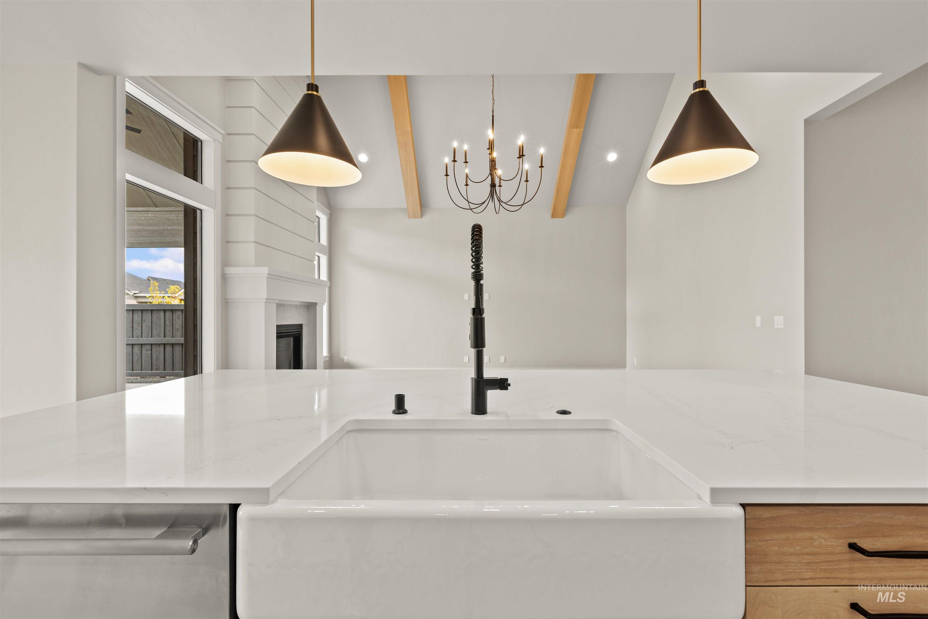 6891 South Utmost Way Meridian, ID 83642 - Photo 20 of 46 Kitchen featuring dishwasher, beamed ceiling, hanging light fixtures, light stone counters, and a fireplace