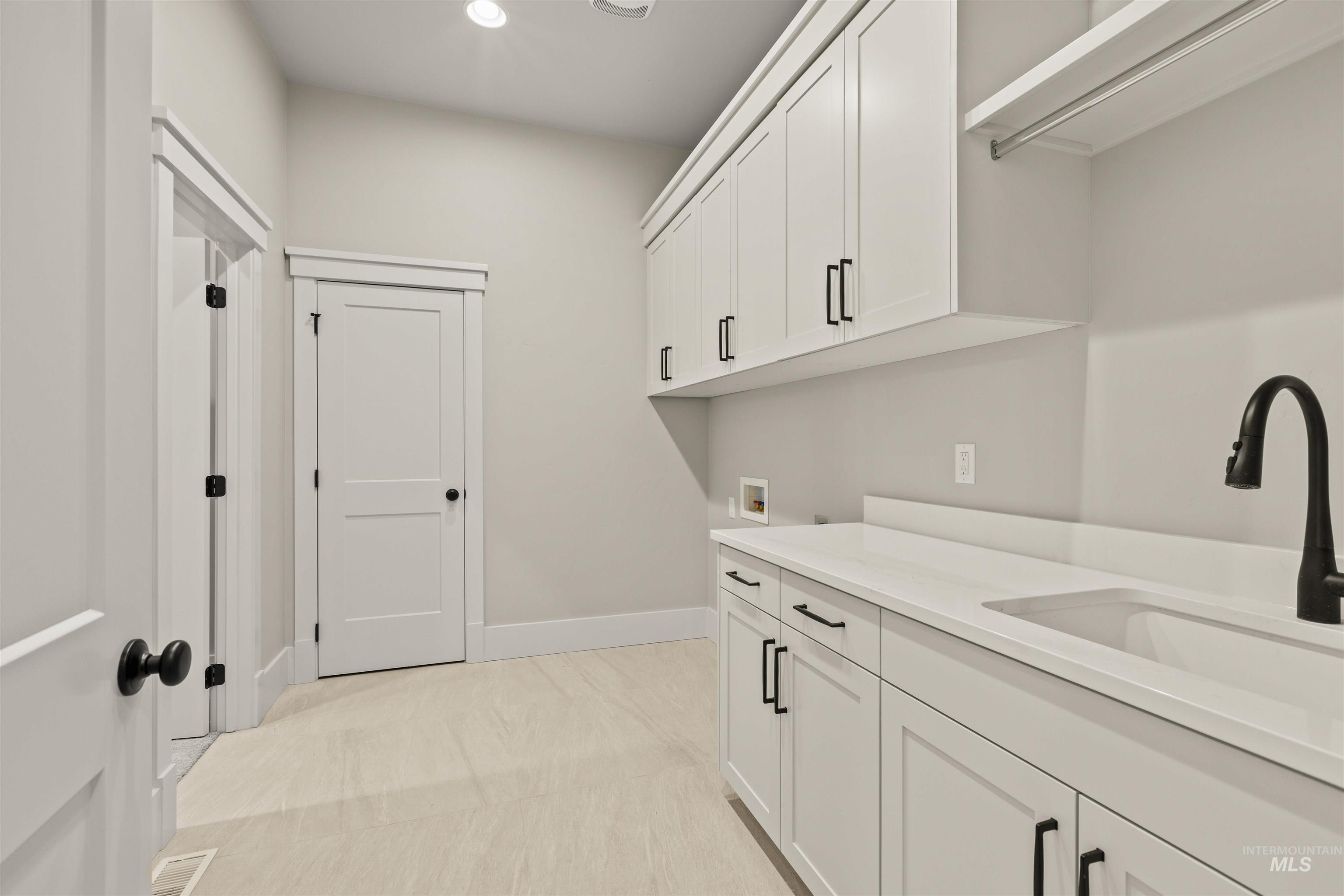 6891 South Utmost Way Meridian, ID 83642 - Photo 33 of 46 Laundry area with cabinet space, recessed lighting, and hookup for a washing machine