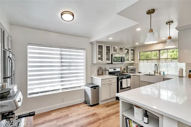a kitchen with stainless steel appliances granite countertop a stove and a sink
