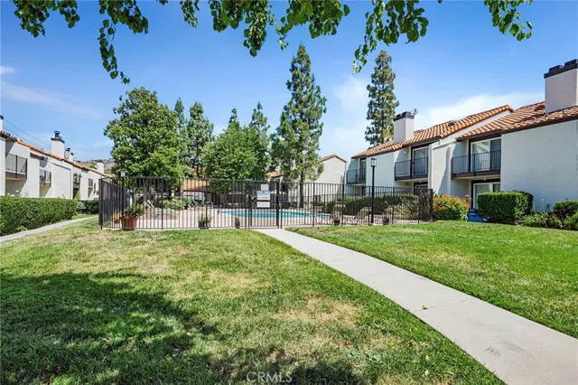 a view of a house with swimming pool and sitting area