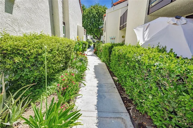 a swimming pool with yard in the back