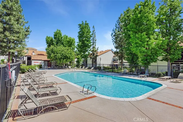 a view of a swimming pool with a lounge chair