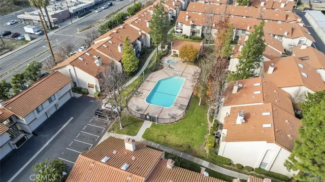 an aerial view of a residential houses with yard