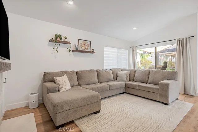 a living room with furniture a fireplace and a flat screen tv