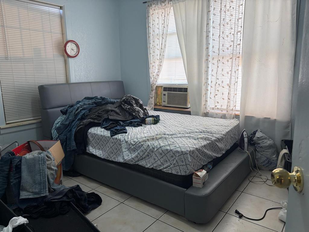 4501 Parrish Road Haltom City, TX 76117 - Photo 13 of 27 a bedroom with a bed and window