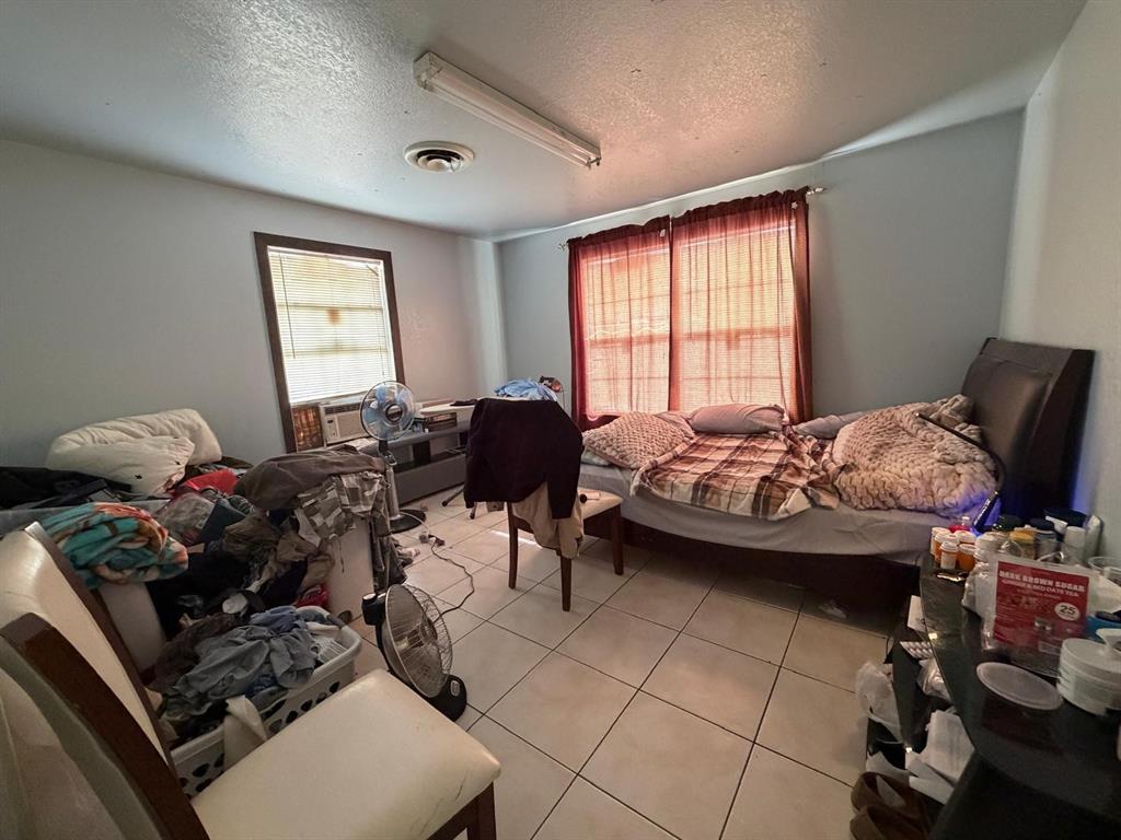 4501 Parrish Road Haltom City, TX 76117 - Photo 15 of 27 a bedroom with furniture and a window