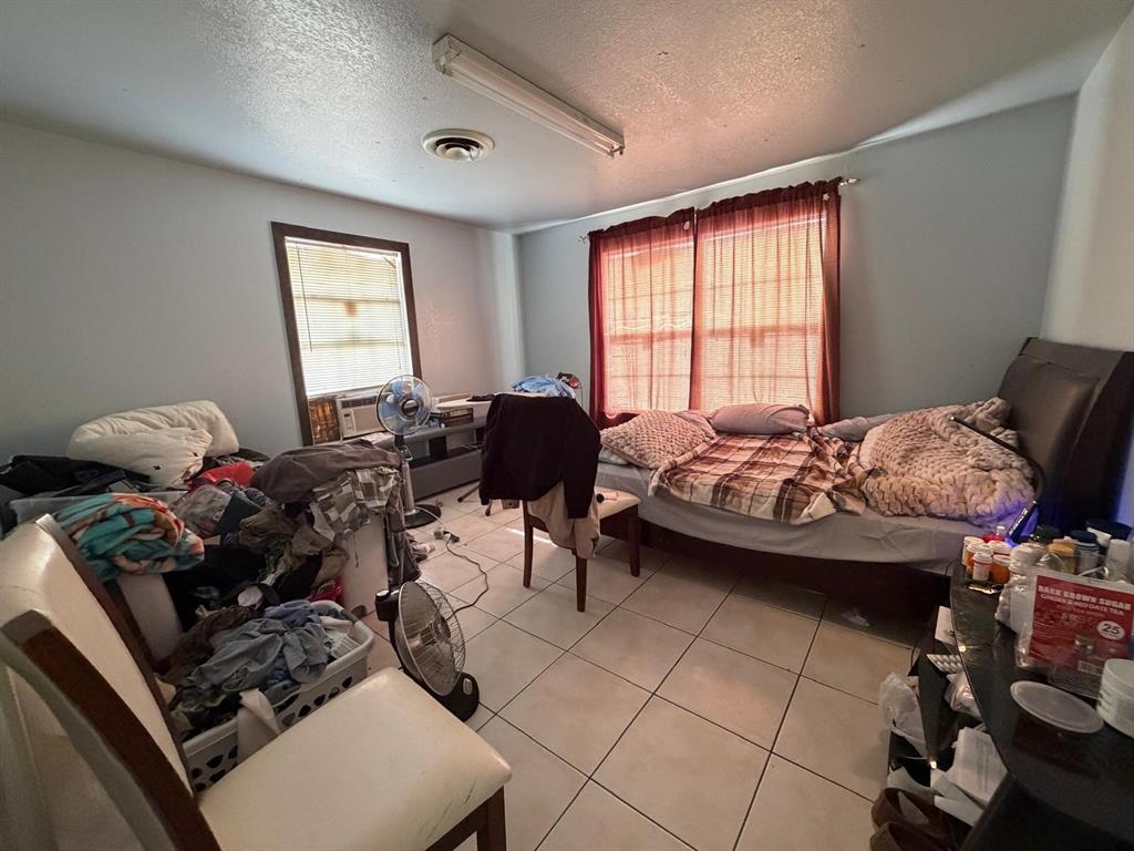 4501 Parrish Road Haltom City, TX 76117 - Photo 16 of 27 a bedroom with furniture or couch and a window