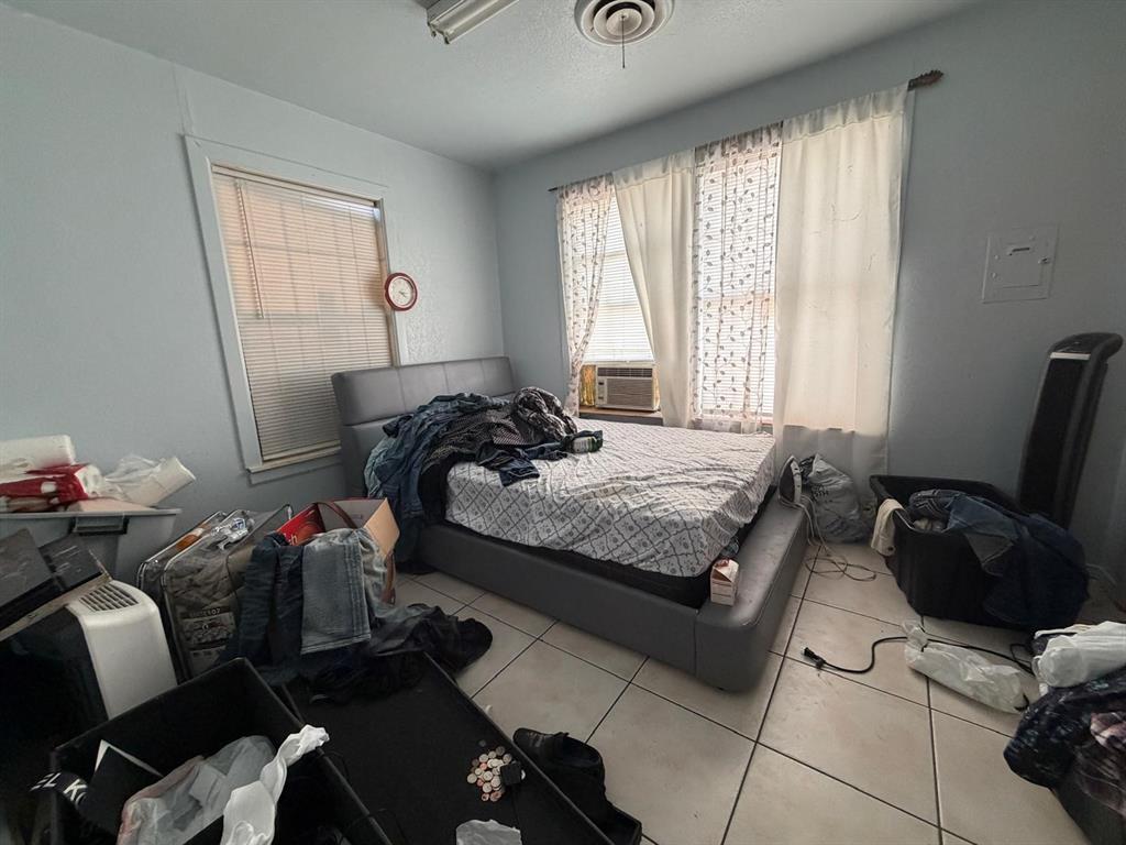 4501 Parrish Road Haltom City, TX 76117 - Photo 17 of 27 a bedroom with a bed and a window