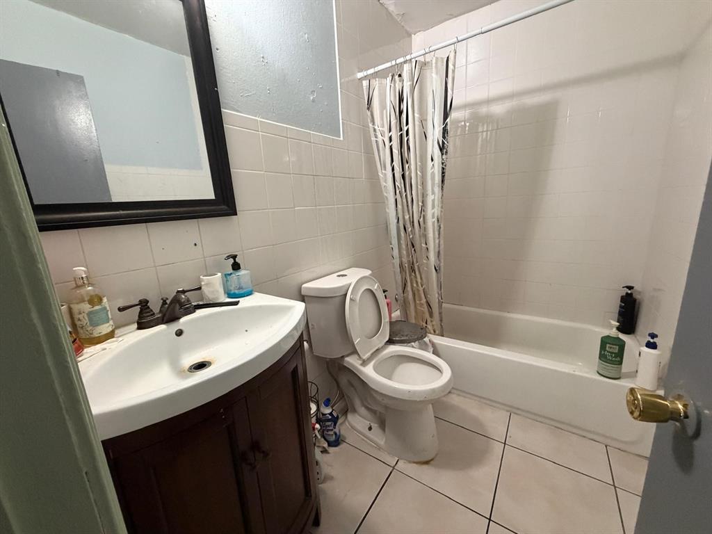 4501 Parrish Road Haltom City, TX 76117 - Photo 18 of 27 a bathroom with a sink toilet a mirror and shower