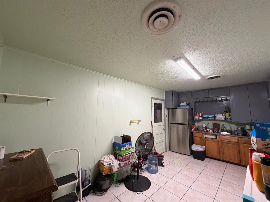4501 Parrish Road Haltom City, TX 76117 - Photo 19 of 27 a kitchen with refrigerator a sink and a stove