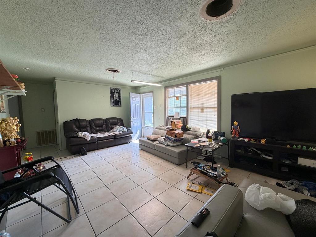 4501 Parrish Road Haltom City, TX 76117 - Photo 20 of 27 a living room with furniture and a flat screen tv