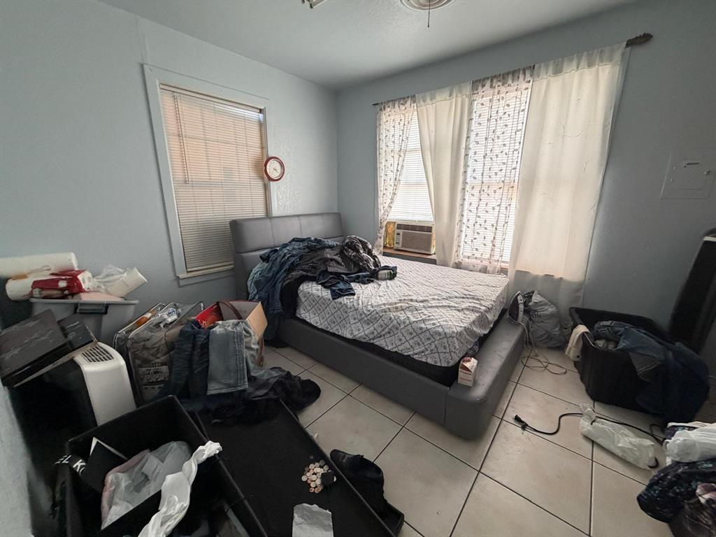 4501 Parrish Road Haltom City, TX 76117 - Photo 23 of 27 a bedroom with a bed and windows