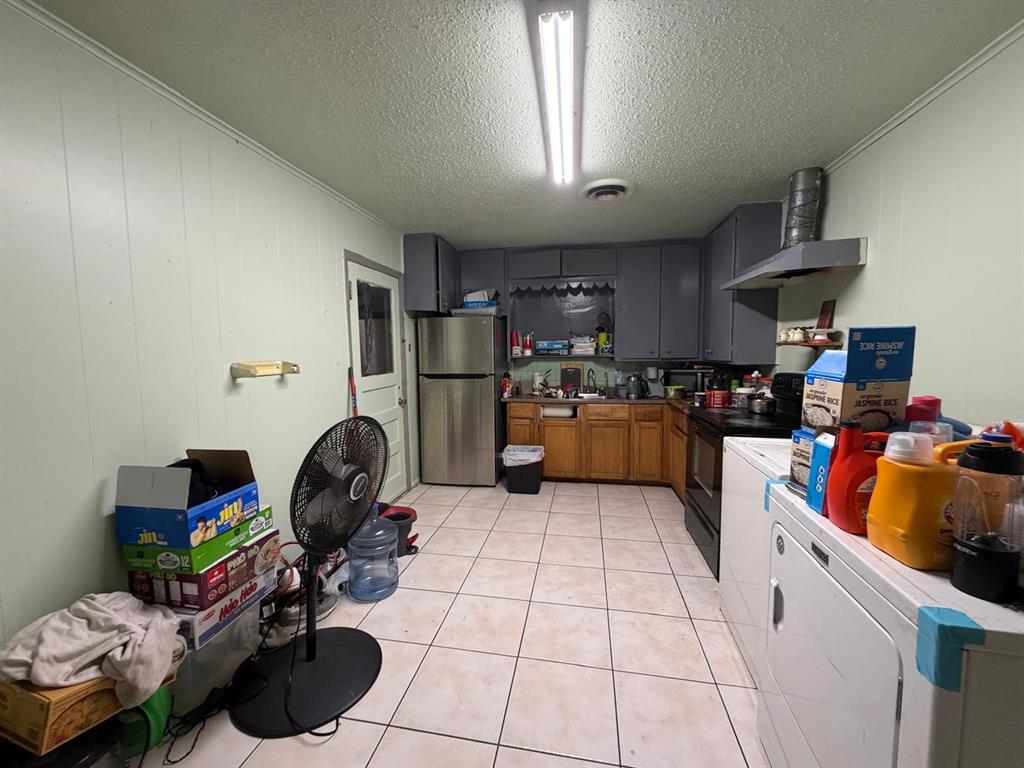 4501 Parrish Road Haltom City, TX 76117 - Photo 10 of 27 a kitchen with stainless steel appliances a sink a stove a refrigerator and cabinets