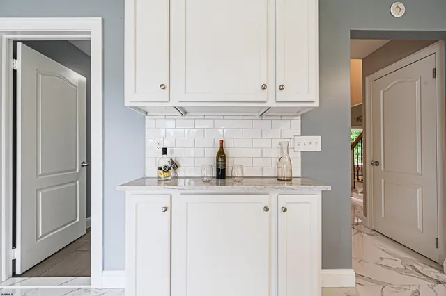 a kitchen with stainless steel appliances granite countertop a refrigerator and cabinets