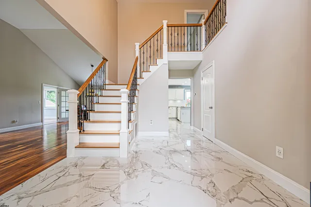 a view of entryway and hall with a front door