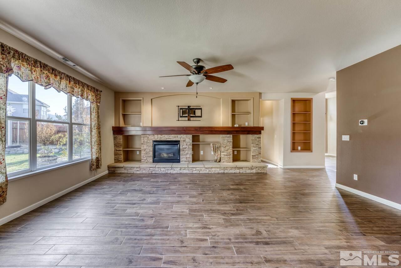 9720 Lemke Court Reno, NV 89521 - Photo 11 of 40 wooden floor fireplace and windows in an empty room