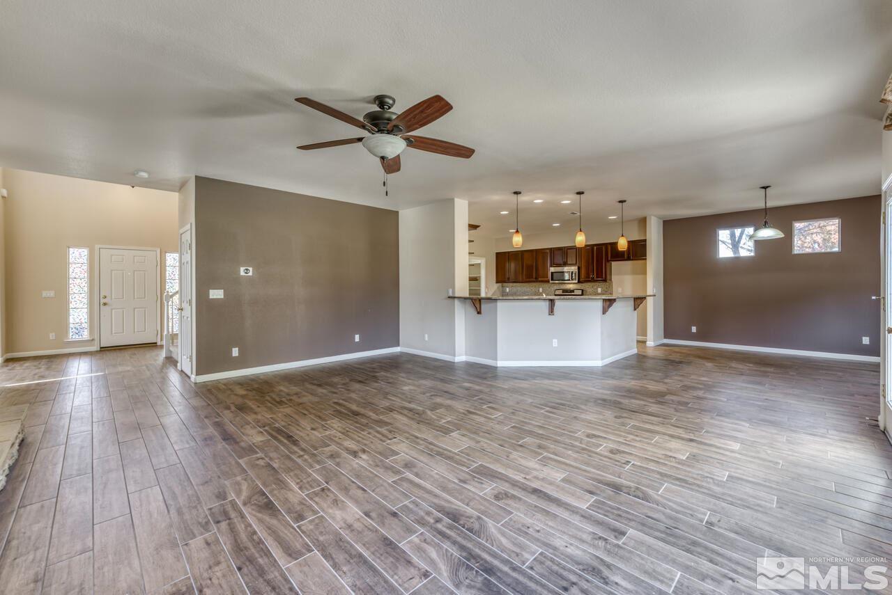 9720 Lemke Court Reno, NV 89521 - Photo 13 of 40 a view of a big room with wooden floor and a kitchen
