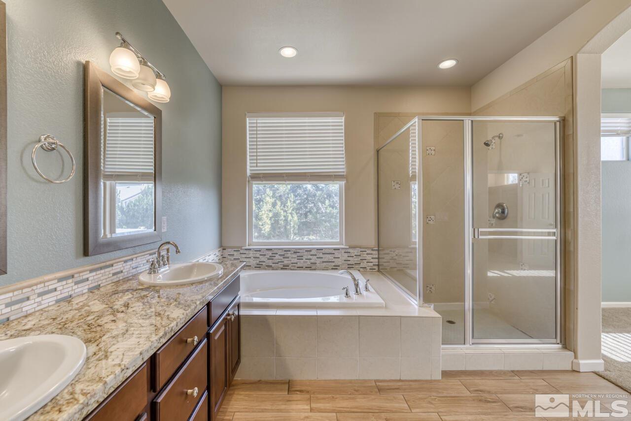 9720 Lemke Court Reno, NV 89521 - Photo 25 of 40 a bathroom with a granite countertop tub sink shower and mirror