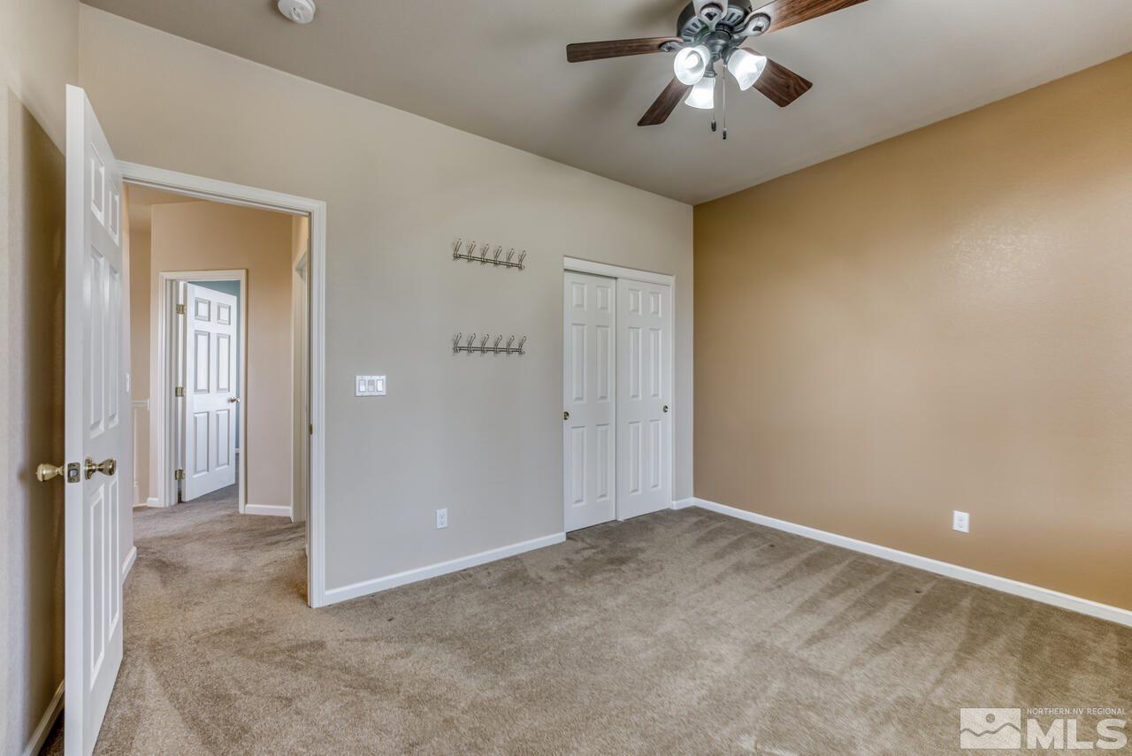 9720 Lemke Court Reno, NV 89521 - Photo 29 of 40 a view of an empty room and chandelier fan