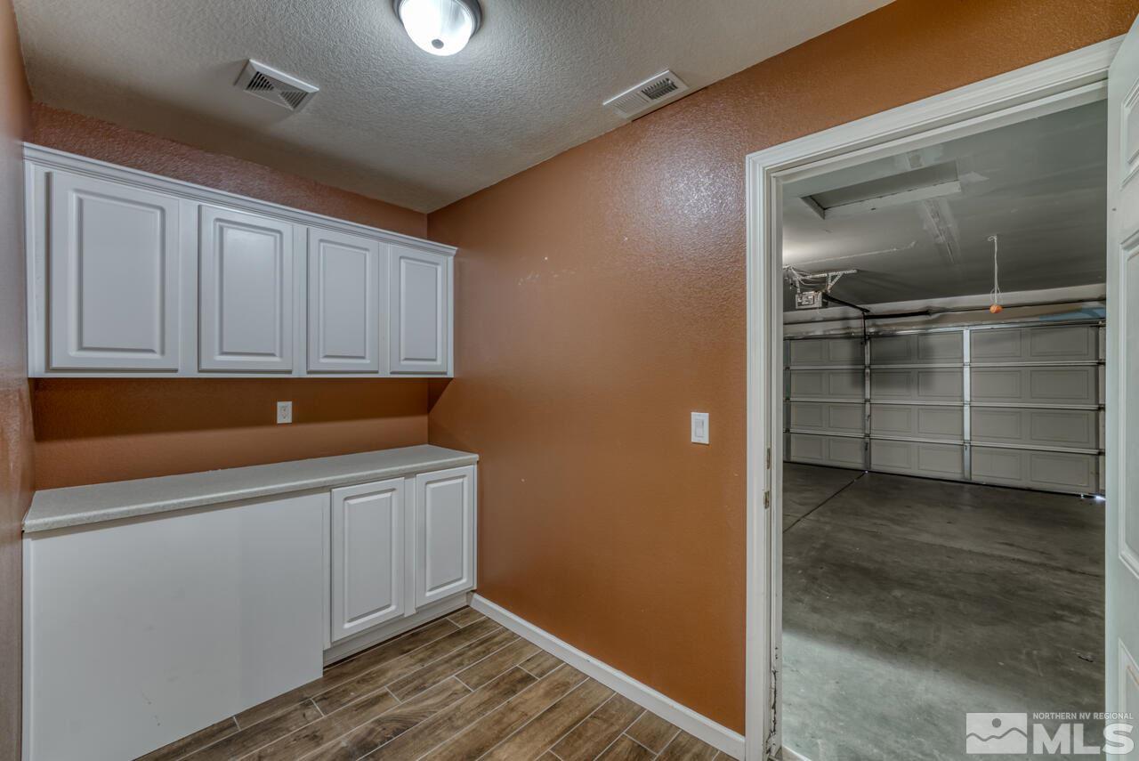 9720 Lemke Court Reno, NV 89521 - Photo 32 of 40 a room with cabinets and a window