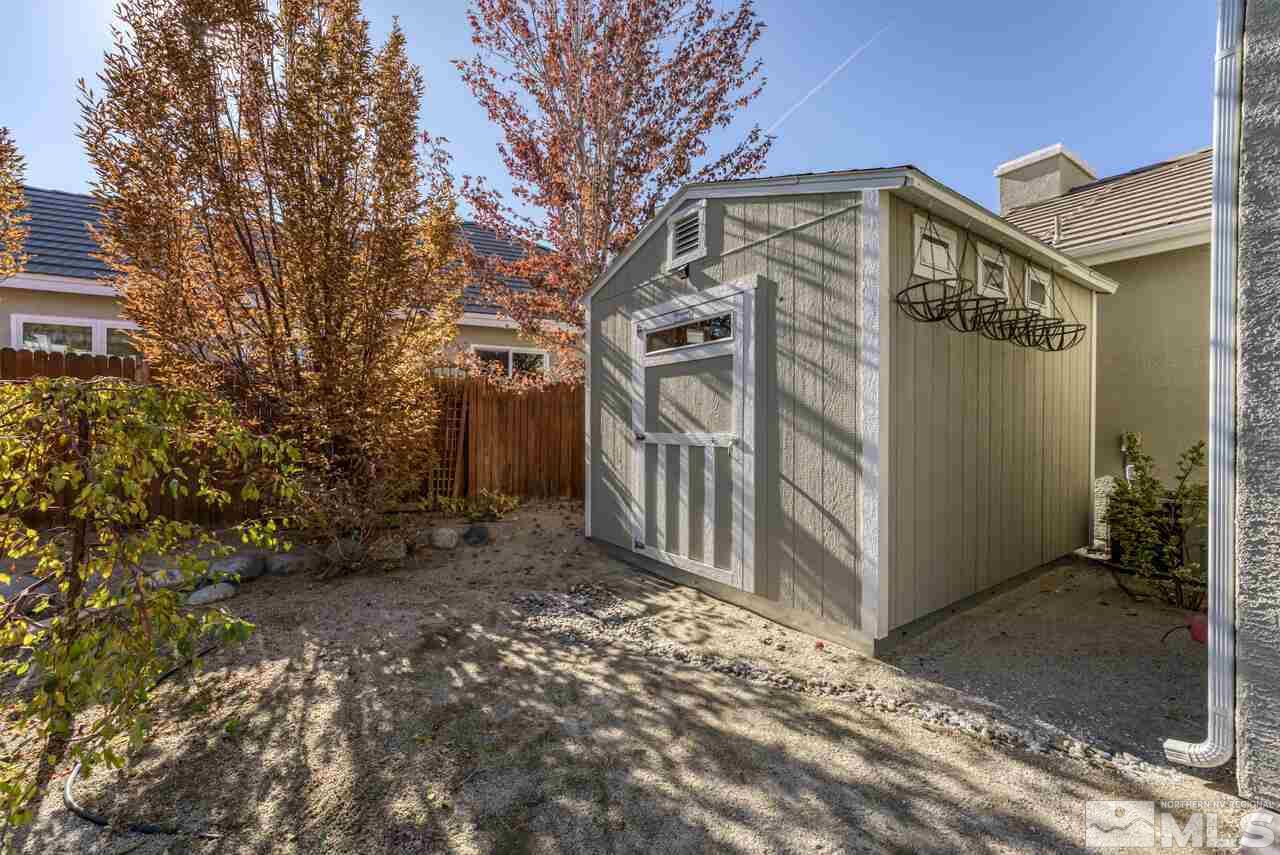 9720 Lemke Court Reno, NV 89521 - Photo 39 of 40 a view of a house with a large tree and wooden fence