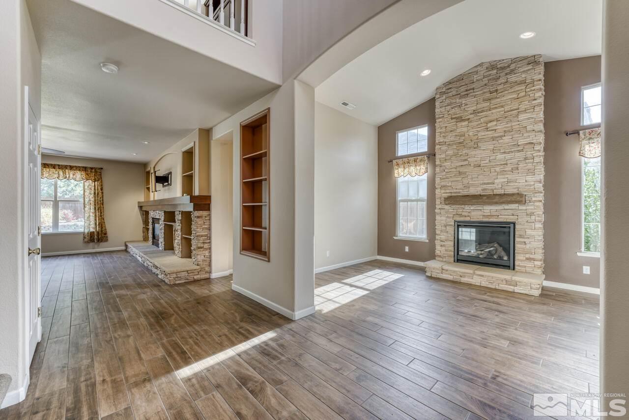 9720 Lemke Court Reno, NV 89521 - Photo 5 of 40 a view of a livingroom with wooden floor and a fireplace