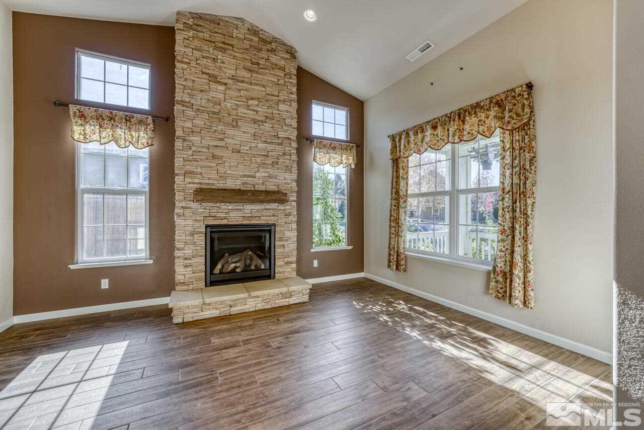 9720 Lemke Court Reno, NV 89521 - Photo 6 of 40 a view of an empty room with exposed radiator and fireplace