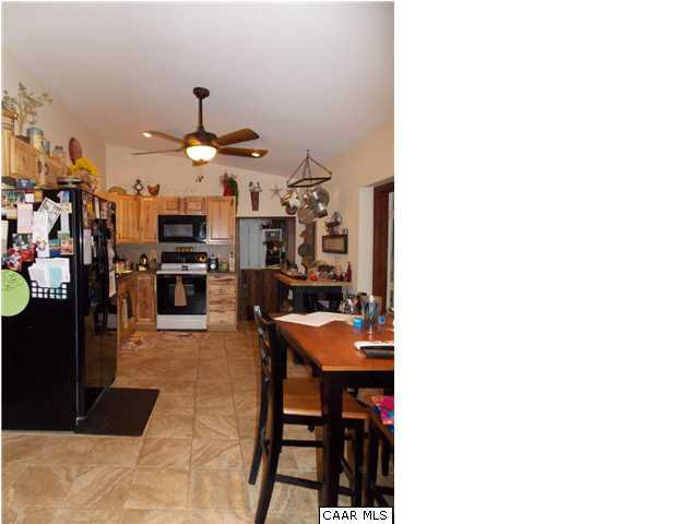 1222 Summerdean Road Middlebrook, VA 24459 - Photo 26 of 42 a room with stainless steel appliances kitchen island a table and chairs in it