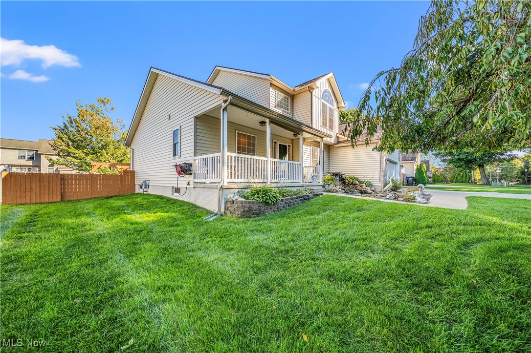 View of front of house featuring a front lawn and covered porch