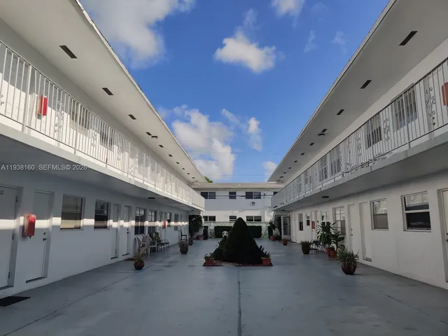 a big room with lots of furniture and a large tree