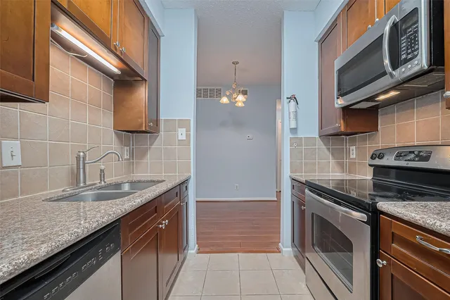 a kitchen with granite countertop a sink and cabinets
