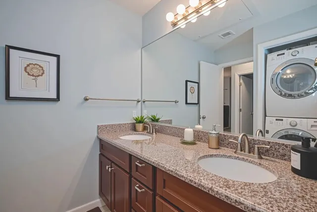 a bathroom with a granite countertop sink a mirror and vanity
