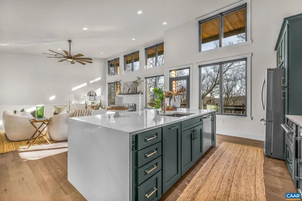 a living room with stainless steel appliances kitchen island granite countertop furniture and a kitchen view