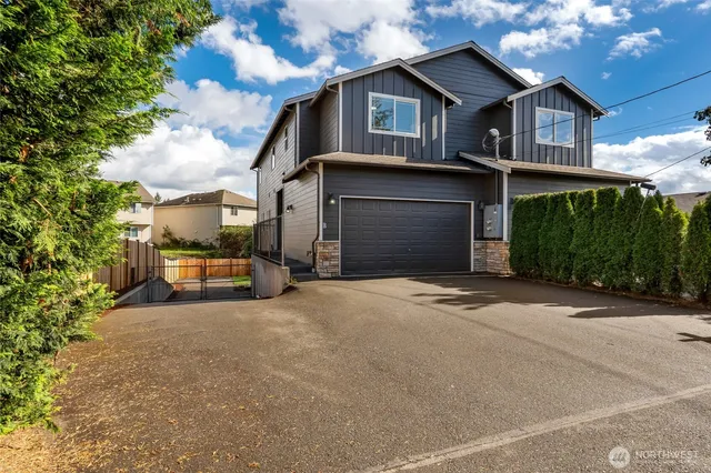 a front view of a house with a yard and garage