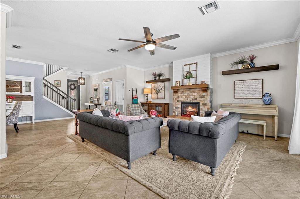 4754 Abaca Circle Naples, FL 34119 - Photo 7 of 46 a living room with furniture and a fireplace