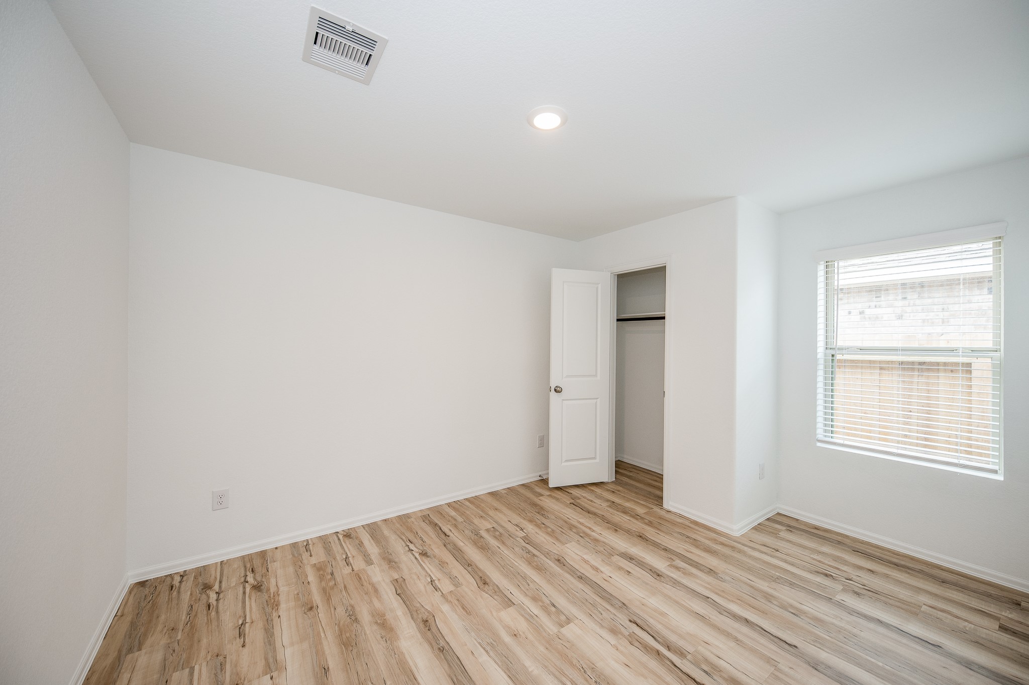 140 Austin Street Angleton, TX 77515 - Photo 22 of 27 Beautiful natural light in this last secondary bedroom for your children or little one as a nursery.