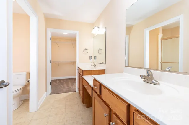 a bathroom with a sink a mirror and a shower