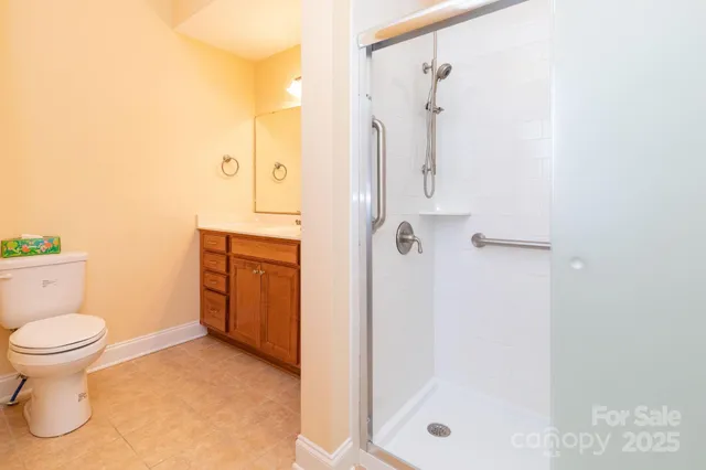 a bathroom with a shower a toilet and a sink