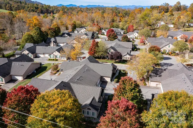 an aerial view of a houses with a swimming pool