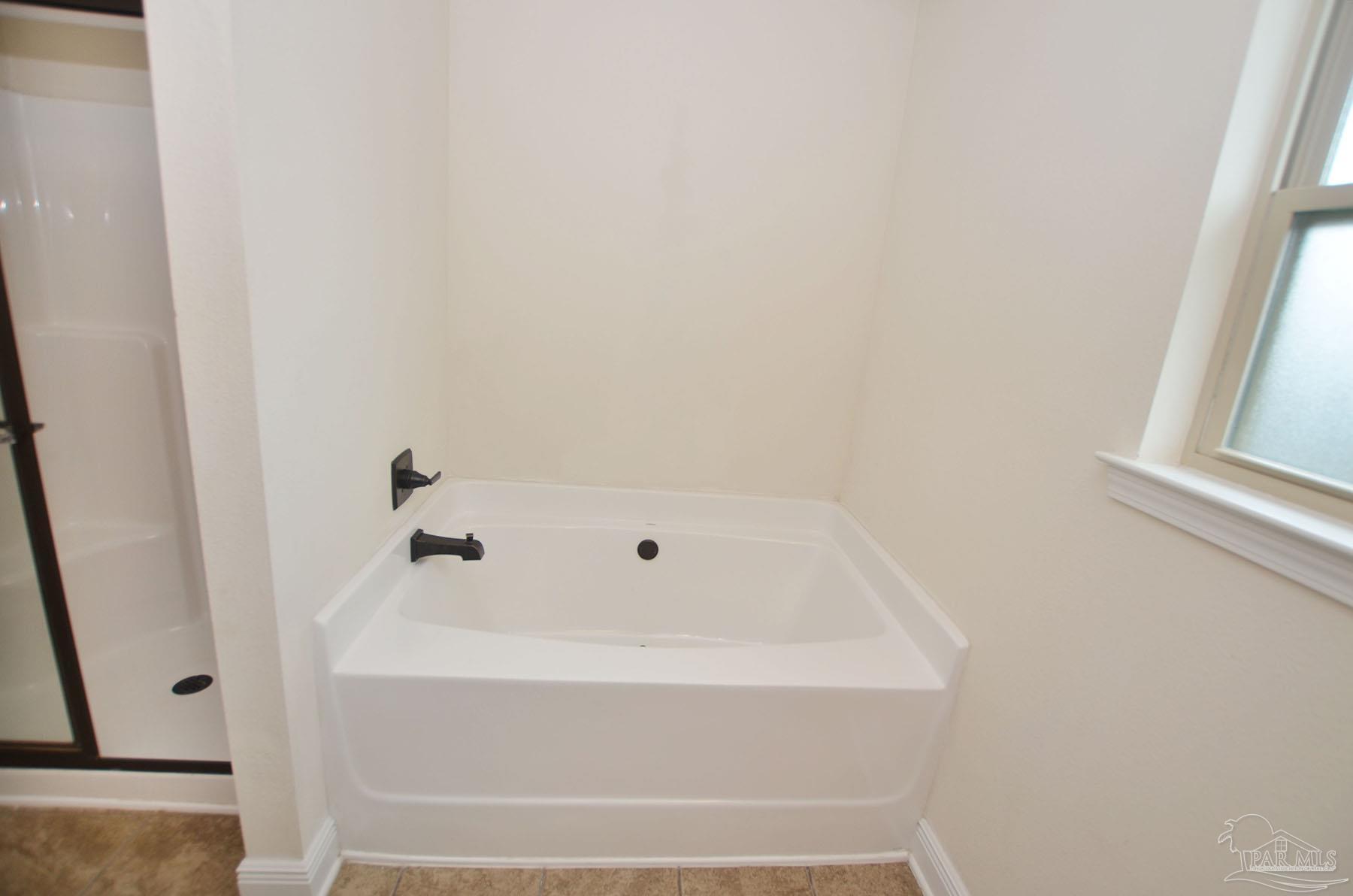 5709 Mill Stream Way Pace, FL 32571 - Photo 25 of 48 a bathroom with bathtub