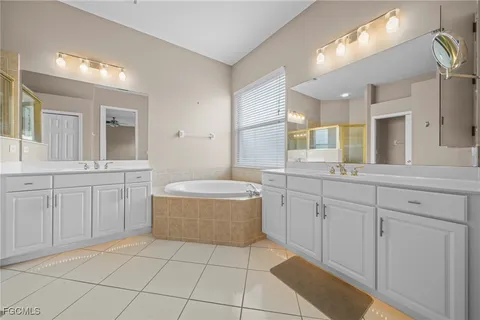 a spacious bathroom with a granite countertop sink a mirror and a