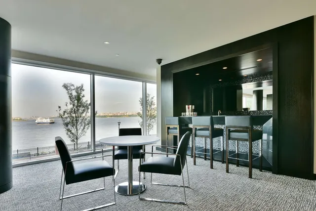 a living room with furniture and a floor to ceiling window