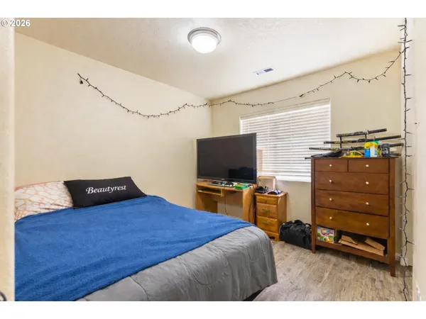 a bedroom with a bed and flat screen tv