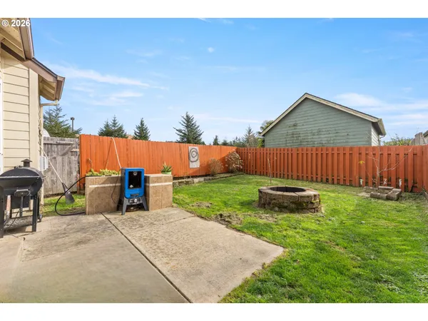 a backyard of a house with table and chairs